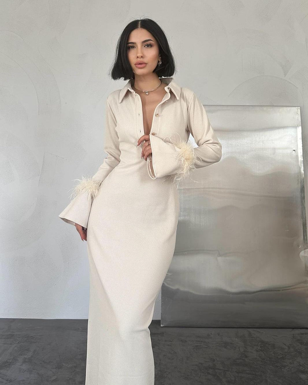 1952  Beige dress with feather detailed sleeves